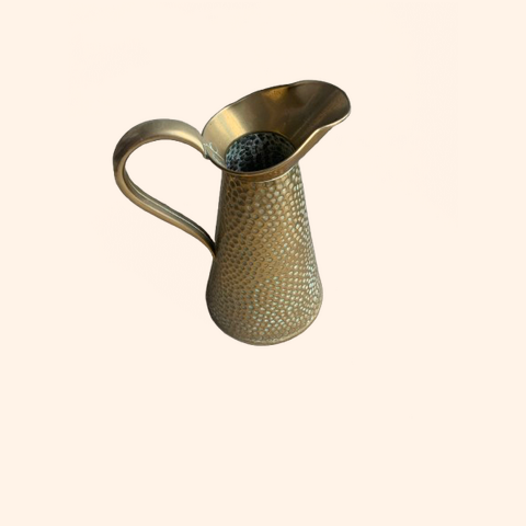 Brass pitcher with a textured surface and curved spout.