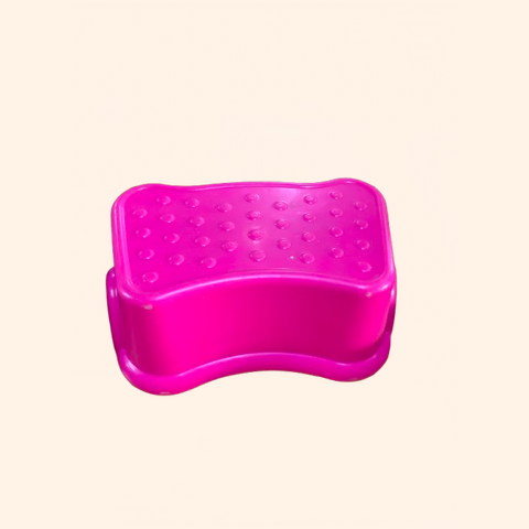 Bright pink, ergonomic step with textured surface.