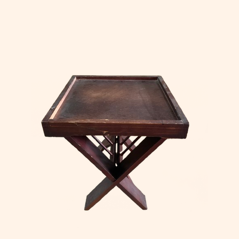 Brown wooden side table with a geometric base.