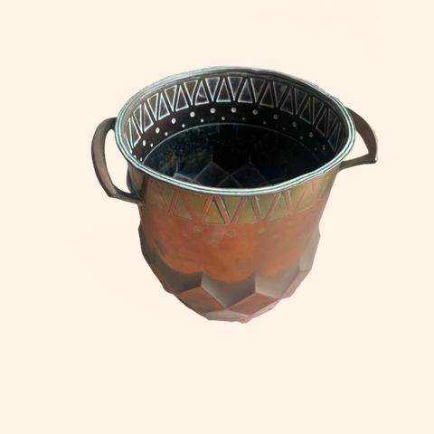 Decorative copper pot with a patterned rim and handles.