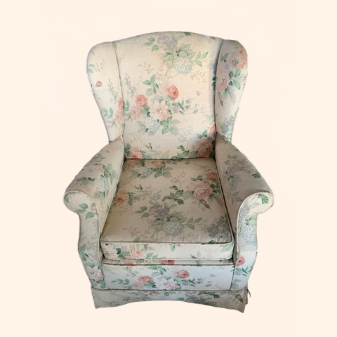 Floral-patterned rocker armchair with a high back and cushioned seat.