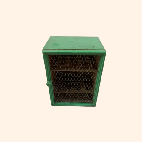 Green wood cabinet, wire mesh door. Antique egg holder.