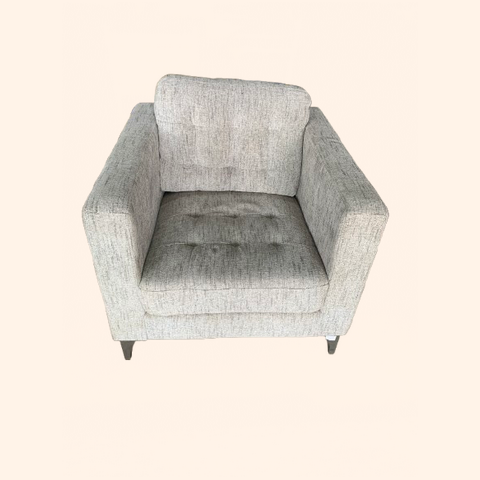 Light gray upholstered armchair with stainless steel legs.