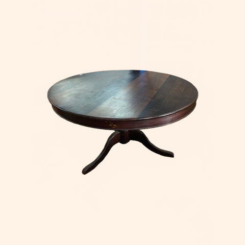 Round wooden table with a central pedestal base.