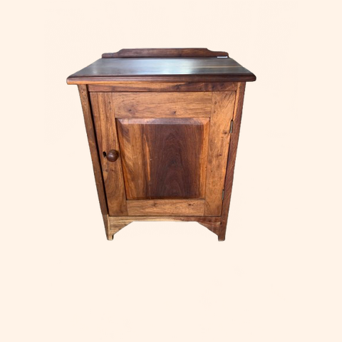 Wooden cabinet with a single door and flat top.