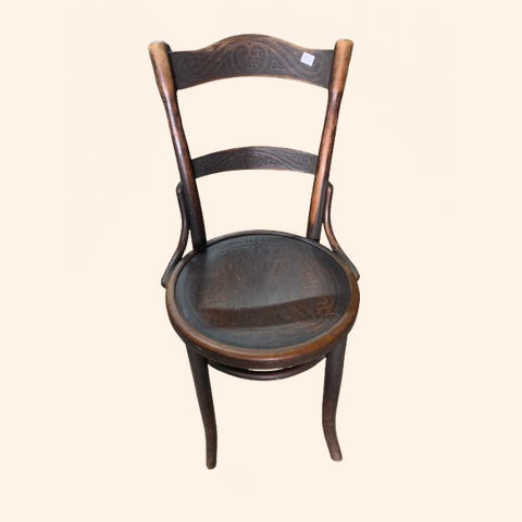 Wooden chair with a curved back and round seat.