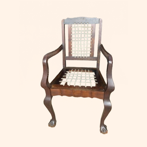 Wooden chair with intricate design and woven seat.