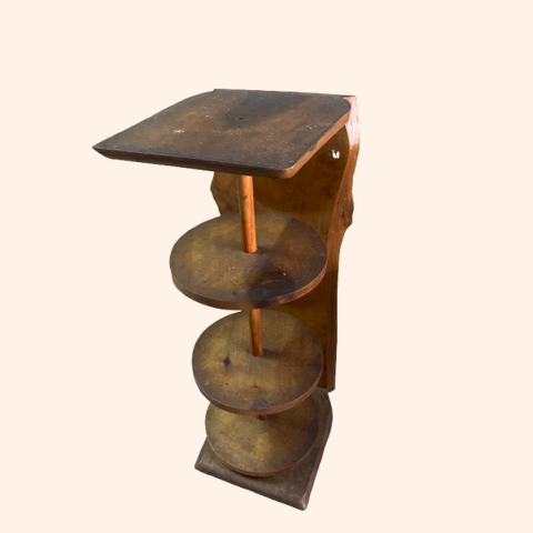 Wooden table with three round tiers and a square top.