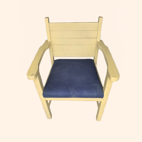 Yellow wooden chair with a blue cushion seat.