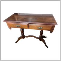 Brown wooden desk with two drawers and curved legs.