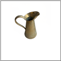 Brass pitcher with a textured surface and curved spout.