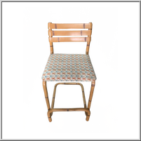 Cane lookalike PVC bar chair with patterned fabric seat cushion.