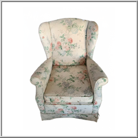 Floral-patterned rocker armchair with a high back and cushioned seat.