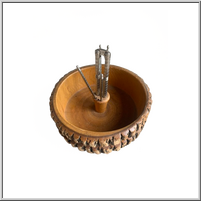 Wooden bowl with a compass inside, intricately carved.