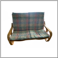 Wooden loveseat with plaid cushions.