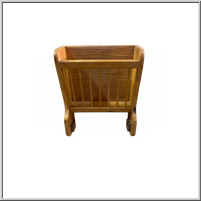 Wooden magazine holder with slatted sides and curved legs.