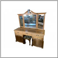 Wooden vanity with three mirrors and a matching stool.