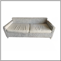 Woven two-seater sofa with cream cushions.